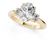 Three-Stone Oval Cut Diamond Ring Set in Yellow gold with Prong Setting and Plain Band