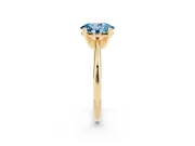 Fancy Blue Oval Cut Diamond Solitaire Ring Set in Yellow gold with Prong Setting on a Plain Round Band
