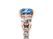 Fancy Blue Three-Stone Cushion Cut Diamond Pavé Band Ring Set in Rose gold with Prong-Set Trio