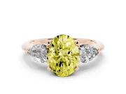 Fancy Yellow Three-Stone Oval Cut Diamond Ring Set in Rose gold with Pear Side Stones and Prong Setting