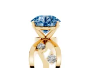 Fancy Blue Round Cut Diamond Solitaire Ring Set in Yellow gold with Side Stones on Criss-Cross Band and Prong Setting