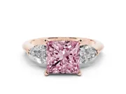 Fancy Pink Three-Stone Princess Cut Diamond Ring Set in Rose gold with Pear Side Stones and Prong Setting