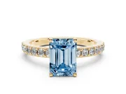 Fancy Blue Emerald Cut Diamond Solitaire Set in Yellow gold with Round Pavé Band and Prong Setting