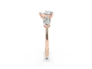 Three-Stone Heart Cut Diamond Ring Set in Rose gold with Pear Side Stones and Prong Setting