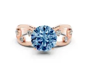 Fancy Blue Round Cut Diamond Solitaire Ring Set in Rose gold with Side Stones on Criss-Cross Band and Prong Setting