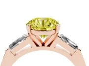 Fancy Yellow Round Cut Diamond Solitaire Ring Set in Rose gold with Tapered Baguette Side Stones and Prong Setting