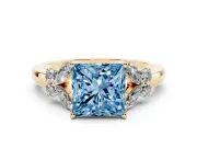 Fancy Blue Princess Cut Diamond Solitaire Floral Ring Set in Yellow gold with Marquise Petals and Prong Setting