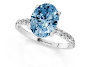 Fancy Blue Oval Cut Diamond Solitaire Ring Set in Platinum with Round Pavé Band and Prong Setting