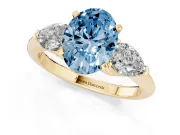 Fancy Blue Three-Stone Oval Cut Diamond Ring Set in Yellow gold with Pear Side Stones and Prong Setting