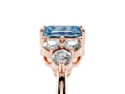 Fancy Blue Emerald Cut Diamond Solitaire Ring Set in Rose gold with Cluster Accents on Each Side