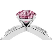 Fancy Pink Round Cut Diamond Solitaire Ring Set in Platinum with Side Stones on Criss-Cross Band and Prong Setting