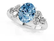 Fancy Blue Oval Cut Diamond Cluster Ring Set in Platinum with Round Accent Stones and Prong Setting on a Plain Band