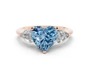 Fancy Blue Three-Stone Heart Cut Diamond Ring Set in Rose gold with Pear Side Stones and Prong Setting