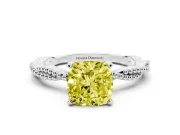 Fancy Yellow Cushion Cut Diamond Solitaire Ring Set in Platinum with Twisted Band and Bead Prong Setting