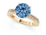 Fancy Blue Round Cut Diamond Solitaire Ring Set in Yellow gold with Slim Pavé Band and Prong Setting
