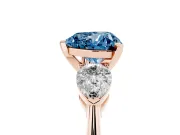 Fancy Blue Three-Stone Heart Cut Diamond Ring Set in Rose gold with Pear Side Stones and Prong Setting