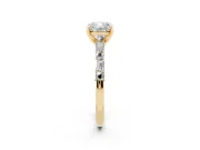 Cushion Cut Diamond Solitaire Set in Yellow gold with Side Baguettes and Channel Set Band