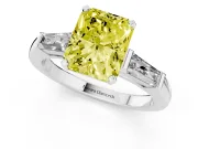 Fancy Yellow Radiant Cut Diamond Solitaire Ring Set in White gold with Tapered Baguette Side Stones and Prong Setting
