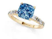 Fancy Blue Cushion Cut Diamond Solitaire Set in Yellow gold with Side Baguettes and Channel Set Band