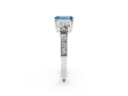 Fancy Blue Emerald Cut Diamond Three-Stone Ring Set in White gold with Round Side Stones and Pavé Band