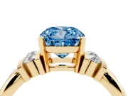 Fancy Blue Three-Stone Cushion Cut Diamond Channel Set Ring Set in Yellow gold with Bar Prongs