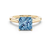 Fancy Blue Princess Cut Diamond Solitaire Ring Set in Yellow gold with Cathedral Band and Prong Setting