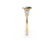 Fancy Black Three-Stone Oval Cut Diamond Ring Set in Yellow gold with Pear Side Stones and Prong Setting