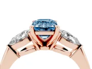 Fancy Blue Three-Stone Emerald Cut Diamond Ring Set in Rose gold with Pear Side Stones and Prong Setting