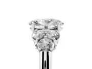 Oval Cut Diamond Cluster Ring Set in Platinum with Round Accent Stones and Prong Setting on a Plain Band