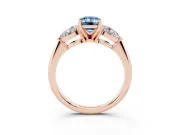 Fancy Blue Three-Stone Emerald Cut Diamond Ring Set in Rose gold with Pear Side Stones and Prong Setting