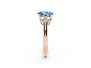 Fancy Blue Oval Cut Diamond Cluster Ring Set in Rose gold with Round Accent Stones and Prong Setting on a Plain Band