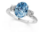 Fancy Blue Oval Cut Diamond Three-Stone Ring Set in White gold with Pavé Band and Graduated Sides