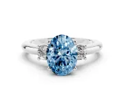 Fancy Blue Three-Stone Oval Cut Diamond Ring Set in Platinum with Prong Setting and Plain Band