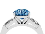 Fancy Blue Round Cut Diamond Solitaire Ring Set in Platinum with Tapered Baguette Side Stones and Prong Setting