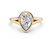 Bezel Set Pear Cut Diamond Solitaire Ring Set in Yellow gold with Tapered Band