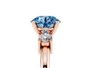 Fancy Blue Three-Stone Round Cut Diamond Ring Set in Rose gold with Prong Setting and Plain Band