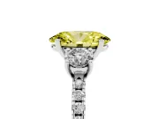 Fancy Yellow Oval Cut Diamond Three-Stone Ring Set in Silver with Pavé Band and Graduated Sides