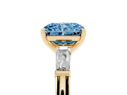 Fancy Blue Radiant Cut Diamond Solitaire Ring Set in Yellow gold with Tapered Baguette Side Stones and Prong Setting