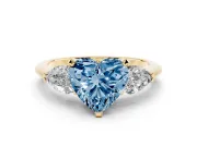 Fancy Blue Three-Stone Heart Cut Diamond Ring Set in Yellow gold with Pear Side Stones and Prong Setting