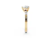 Heart Cut Diamond Solitaire Ring Set in Yellow gold with Tapered Baguette Side Stones and Prong Setting