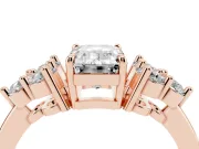 Emerald Cut Diamond Solitaire Ring Set in Rose gold with Cluster Accents on Each Side