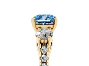 Fancy Blue Three-Stone Cushion Cut Diamond Pavé Band Ring Set in Yellow gold with Prong-Set Trio