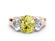 Fancy Yellow Three-Stone Oval Cut Diamond Ring Set in Rose gold with Matching Prong Settings and Plain Band