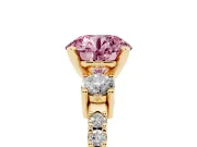 Fancy Pink Three-Stone Round Cut Diamond Pavé Band Ring Set in Yellow gold with Prong Setting