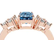 Fancy Blue Emerald Cut Diamond Solitaire Ring Set in Rose gold with Cluster Accents on Each Side