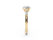 Round Cut Diamond Solitaire Ring Set in Yellow gold with Tapered Baguette Side Stones and Prong Setting