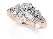 Oval Cut Diamond Cluster Ring Set in Rose gold with Round Accent Stones and Prong Setting on a Plain Band