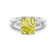 Fancy Yellow Radiant Cut Diamond Solitaire Ring Set in Platinum with Tapered Baguette Side Stones and Prong Setting