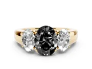 Fancy Black Three-Stone Oval Cut Diamond Ring Set in Yellow gold with Matching Prong Settings and Plain Band
