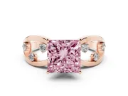 Fancy Pink Princess Cut Diamond Solitaire Ring Set in Rose gold with Side Stones on Criss-Cross Band and Prong Setting